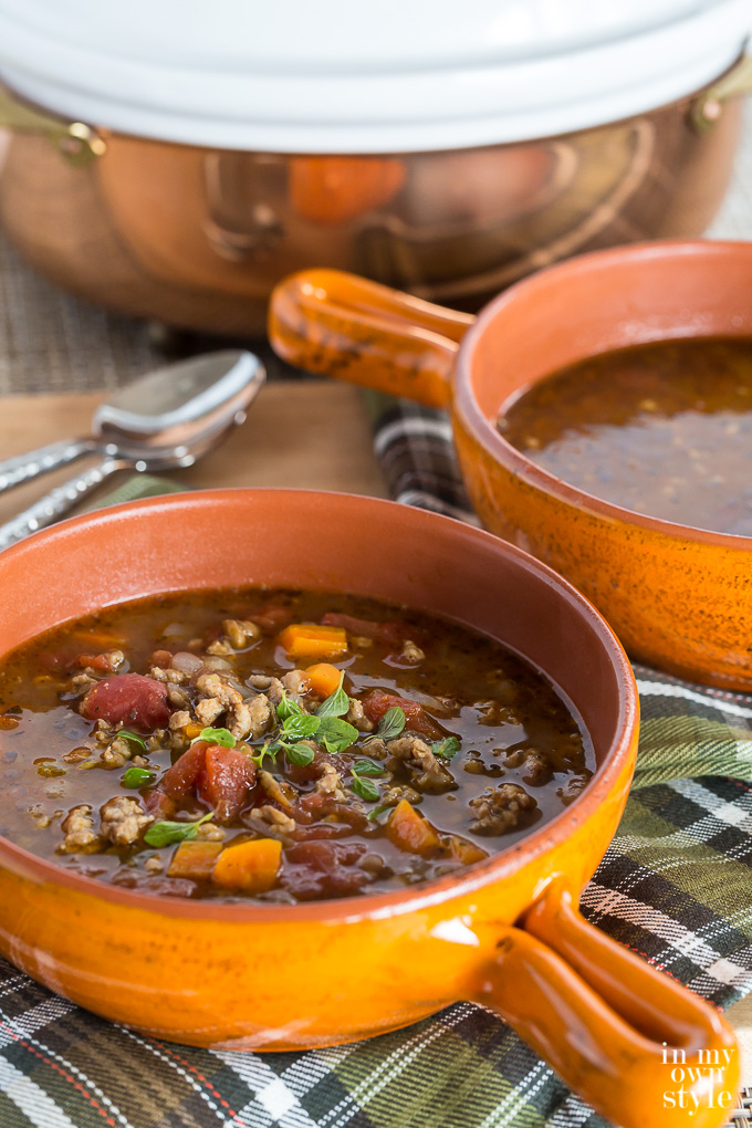 Sausage and Lentil Soup in orange bowl
