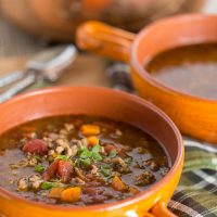 Sausage and Lentil Soup in orange bowl