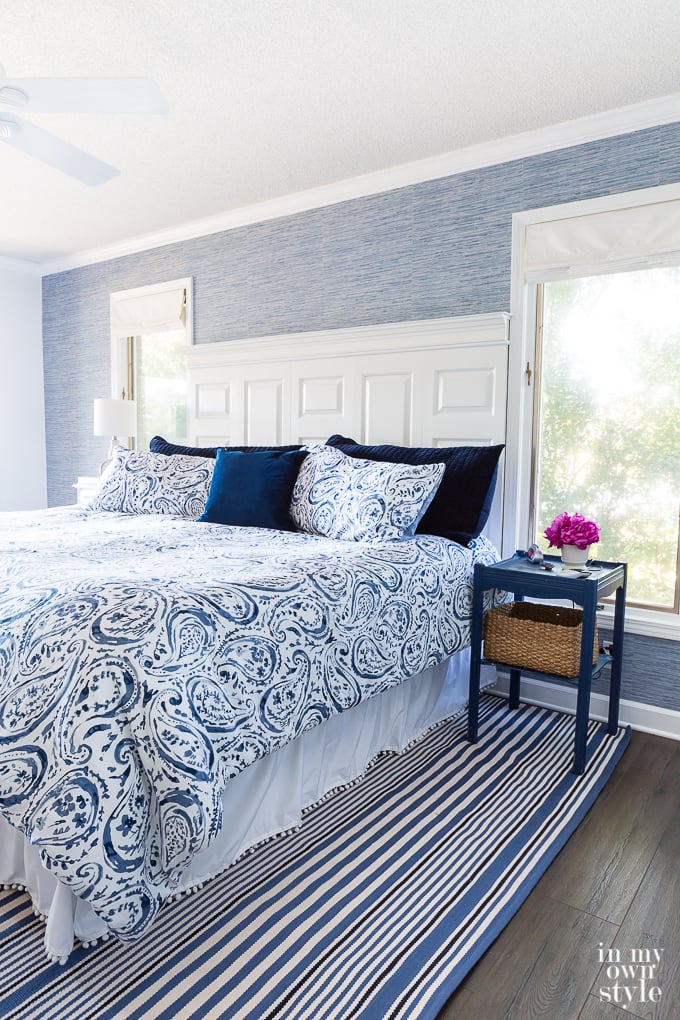 Blue grasscloth wallpaper used as a color accent on a wall in bedroom.
