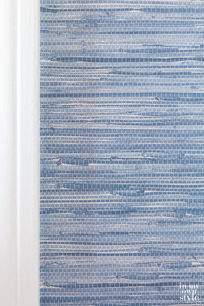 Blue grasscloth wallpaper on wall