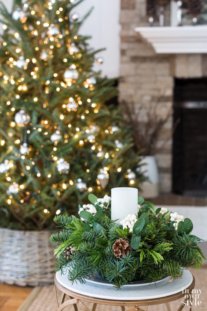 Christmas tree and fresh greenery centerpiece with pillar candle