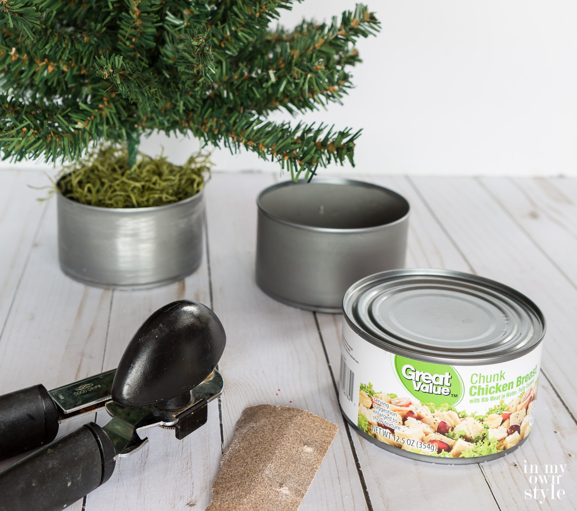 Metal tuna and chicken cans can be used as mini Christmas tree bases.