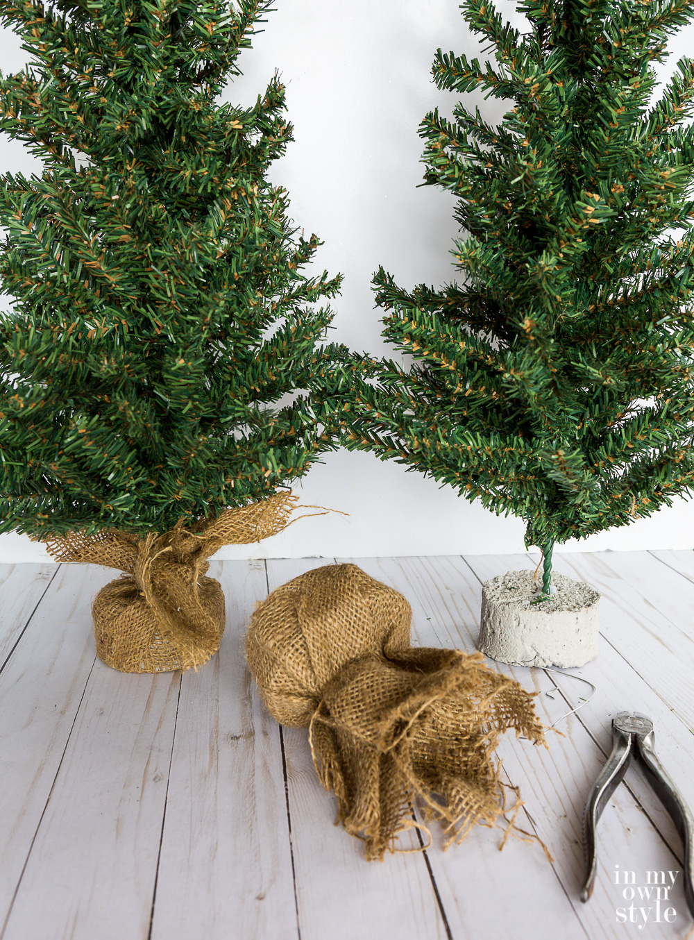 Small Christmas tree with burlap base restyled with a metal base. Easy DIY project.
