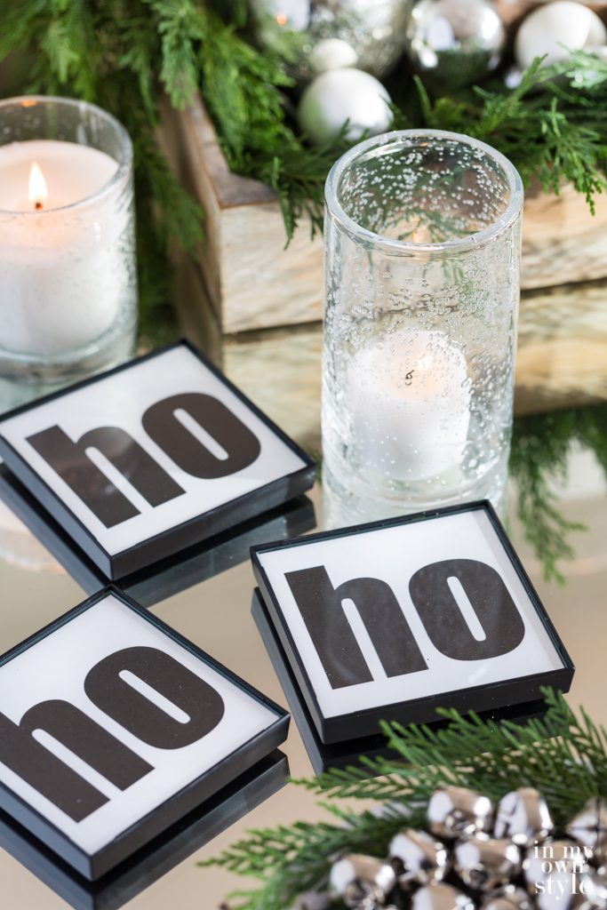 DIY black and white HO HO HO coasters on table