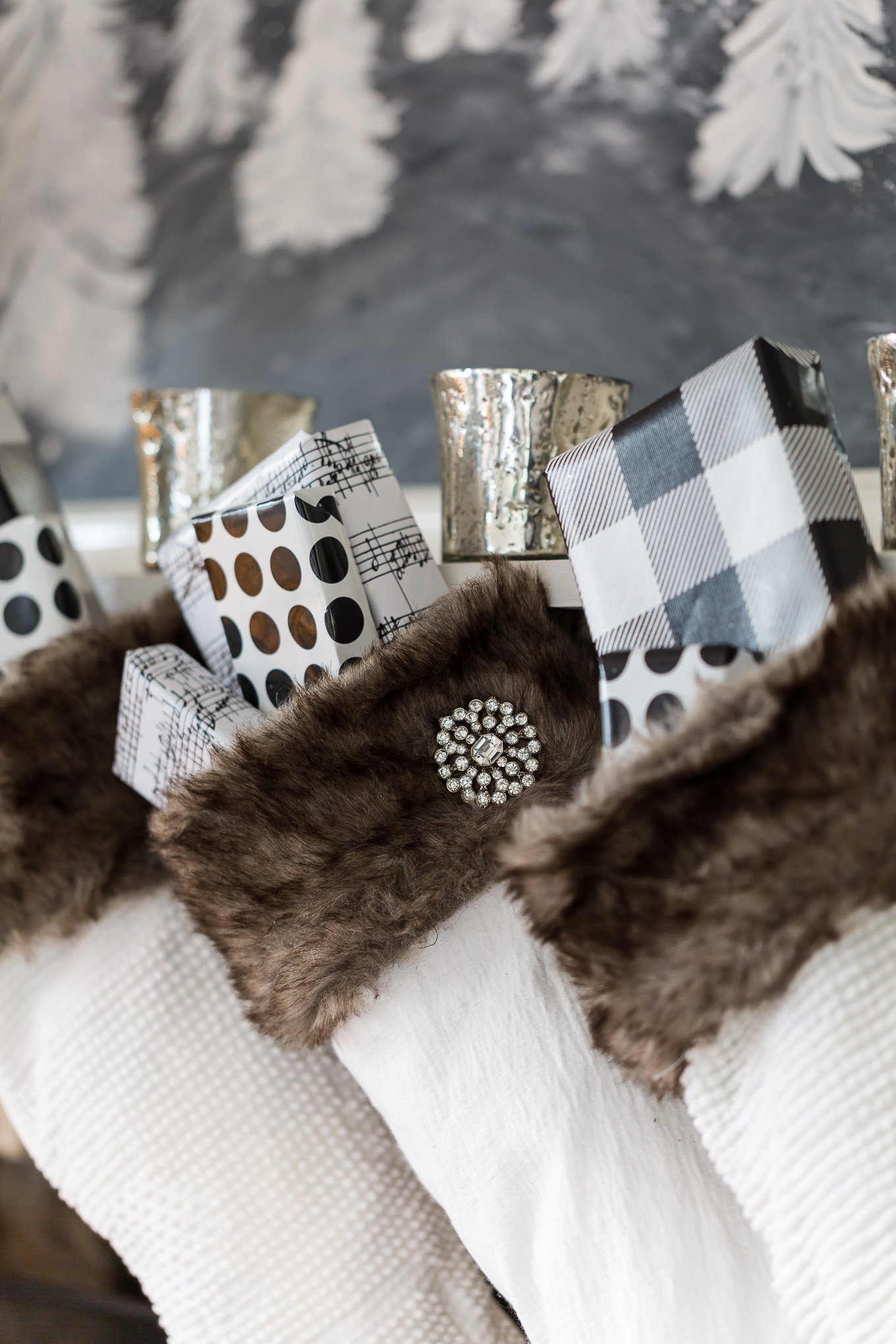White stockings with brown fur lined cuffs on a mantel.