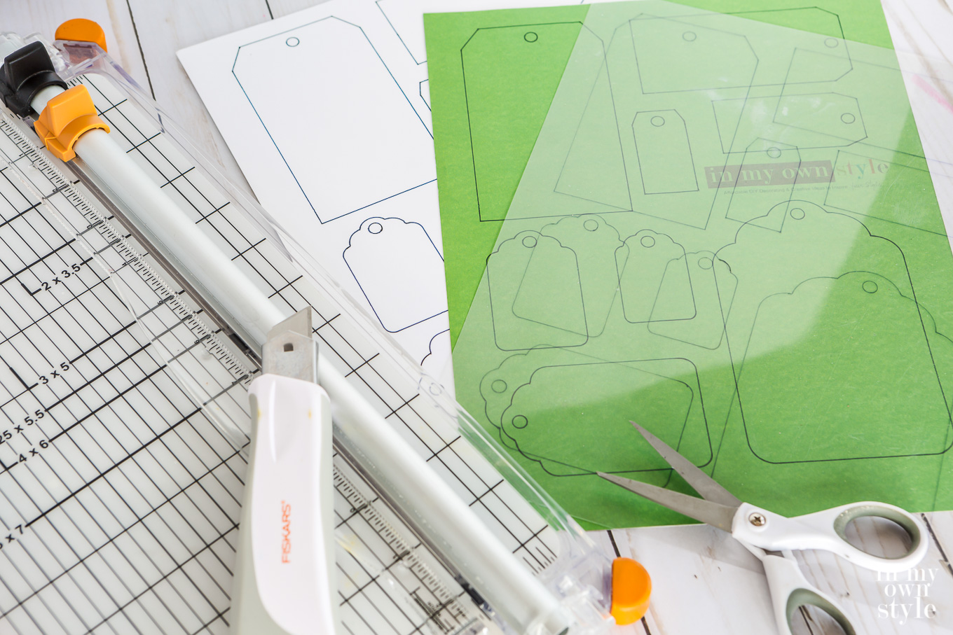 Gift tag free printable being cut on paper cutter.