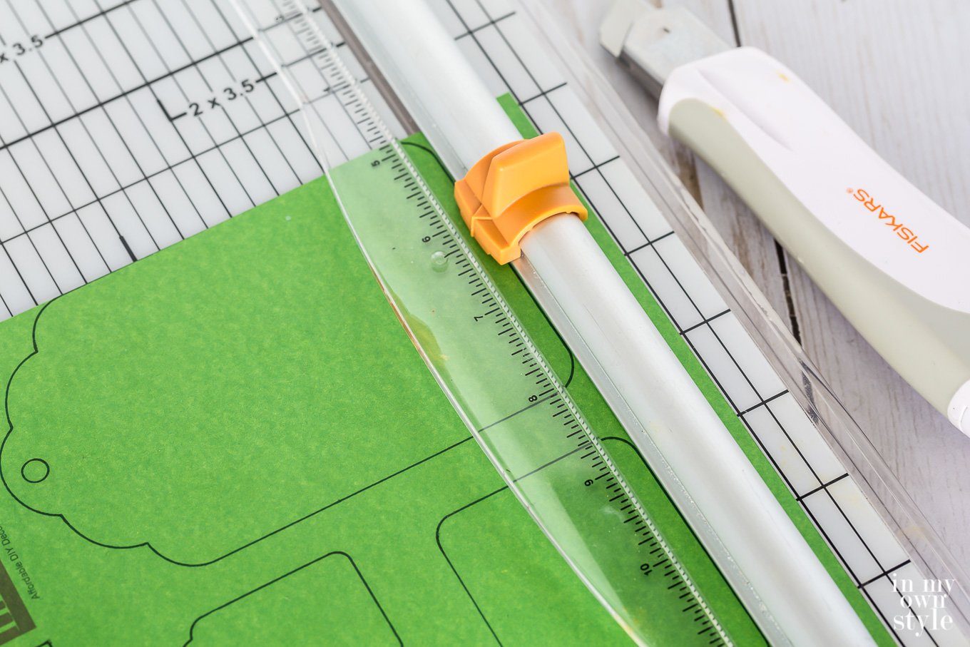 Gift tag free printable being cut on paper cutter.