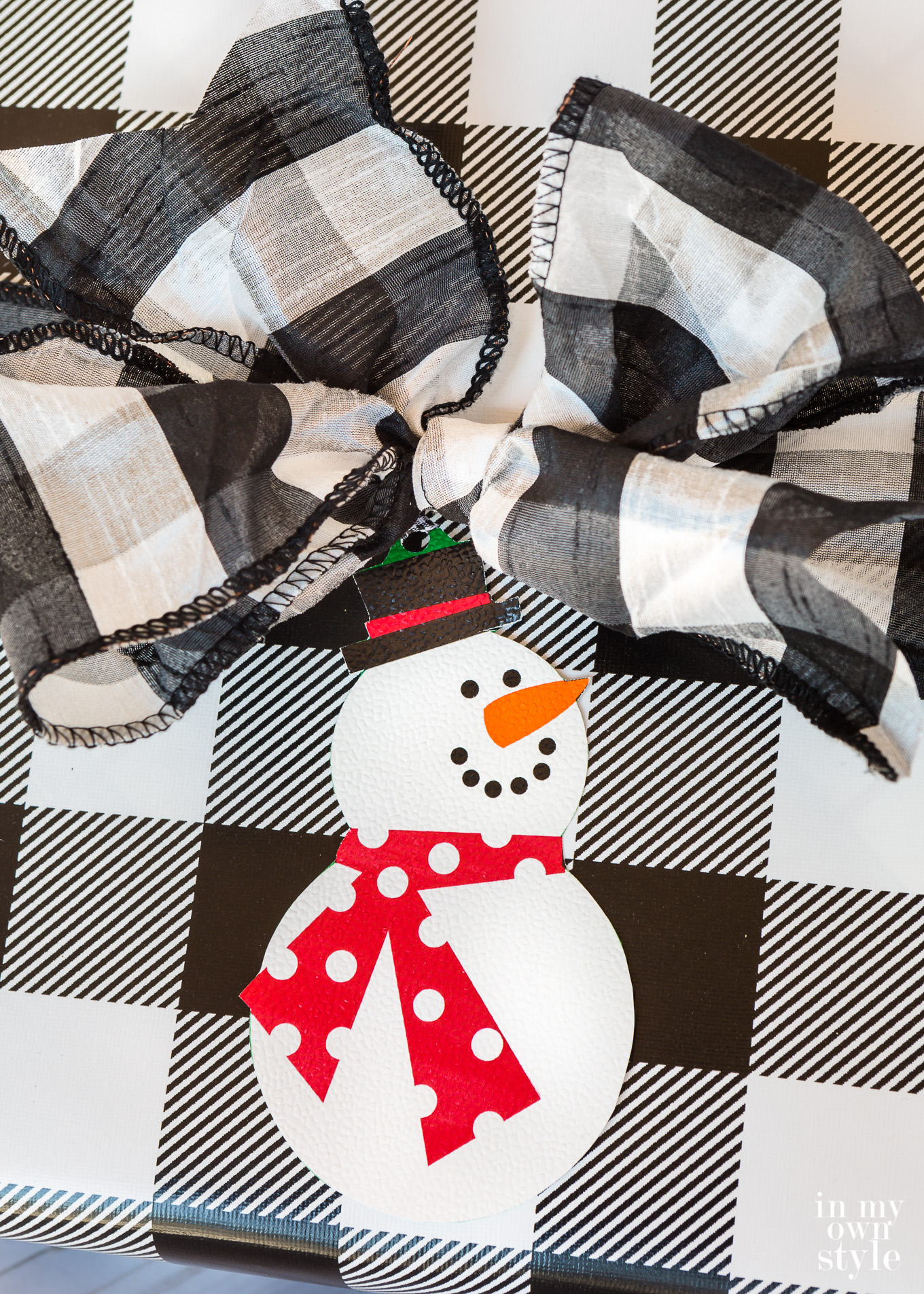 Christmas gift tag of a snowman made using wrapping paper