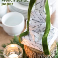 Small boxes stacked into a Christmas tree shape. Each box is wrapped in Free printable French Script paper.