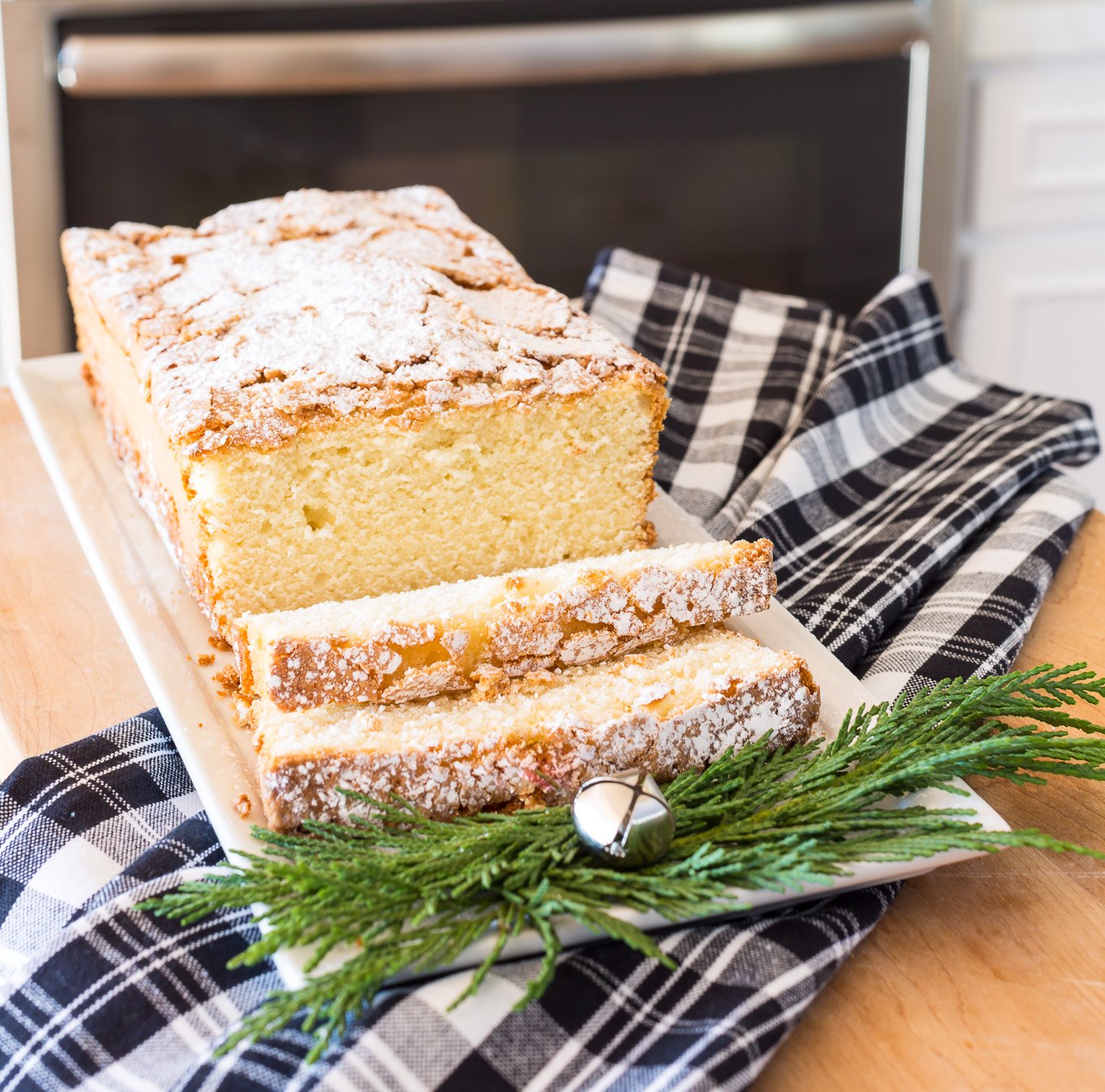 Old Fashioned Lemon Pound Cake sliced on long white plate