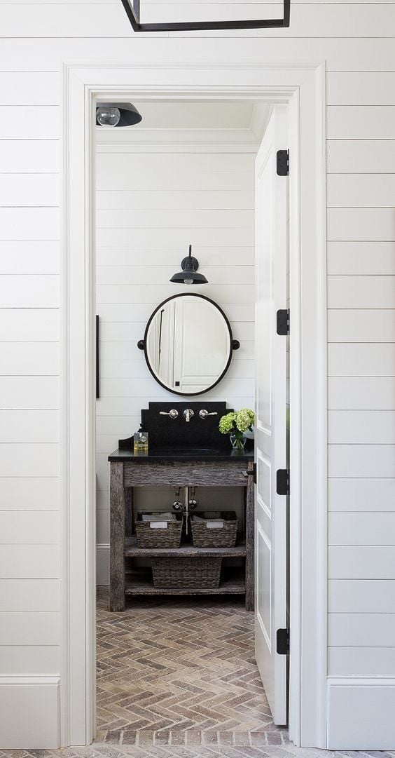 Whitewashed brick floor in bathroom with shiplap walls