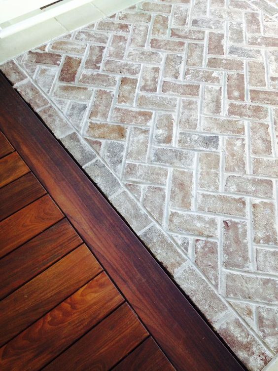 Whitewashed brick floor next to wood floor