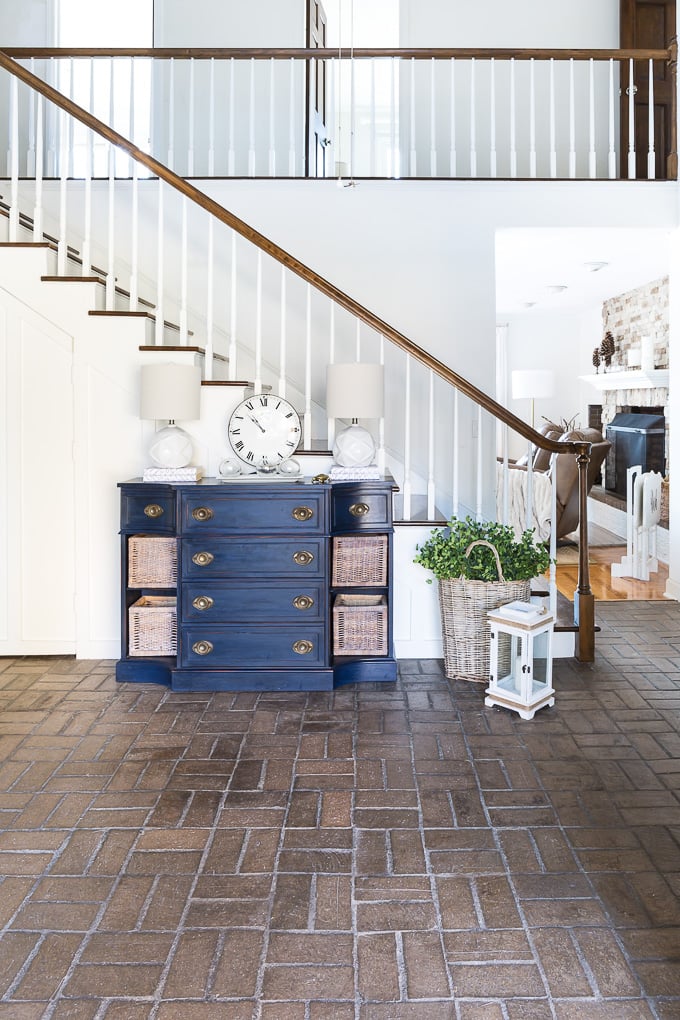 Looking from entryway of house into brick floored foyer.