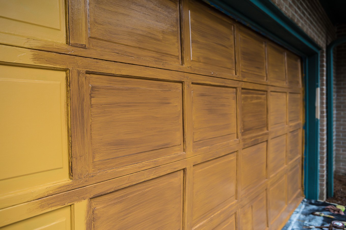 putting second color of paint on garage door being painted to look like it has woodgrain