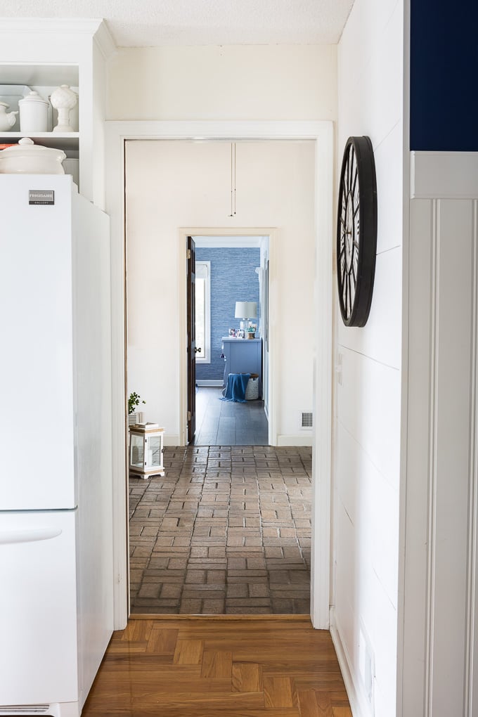 View of brick foyer floor from adjacent room in house