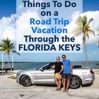 Two people standing next to convertible car on Highway 1 in the Florida Keys