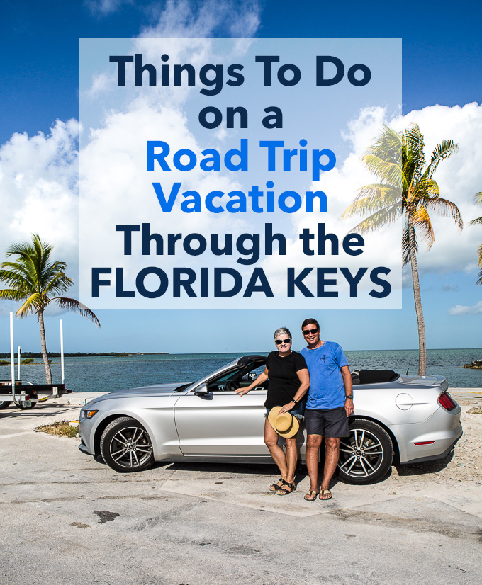 Two people standing next to convertible car on Highway 1 in the Florida Keys