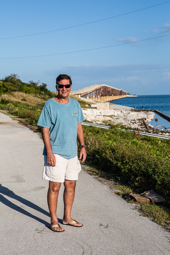 Ed standing along road with view of one of the Florida Keys bridges in the background