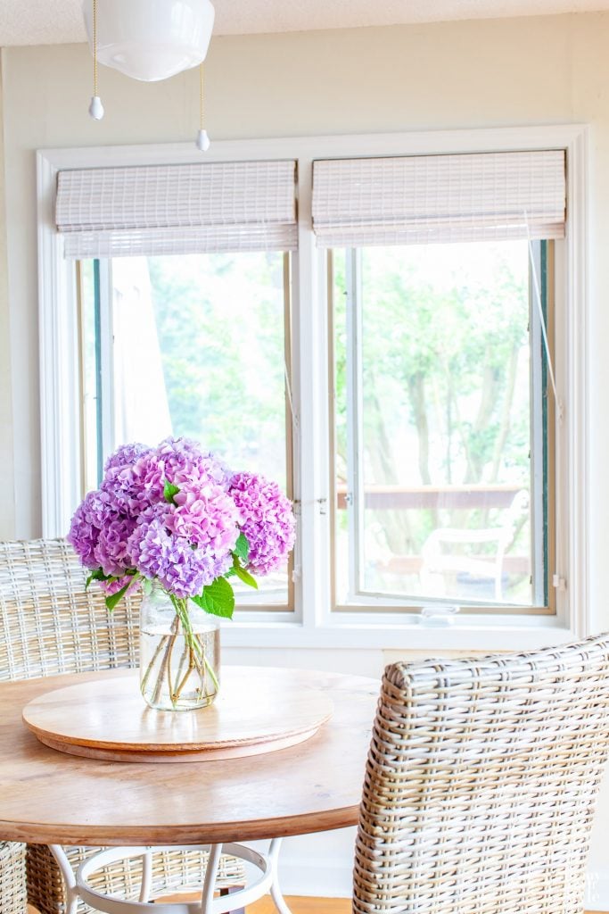 Just cut pink hydrangeas from the garden in a vase on a kitchen table.