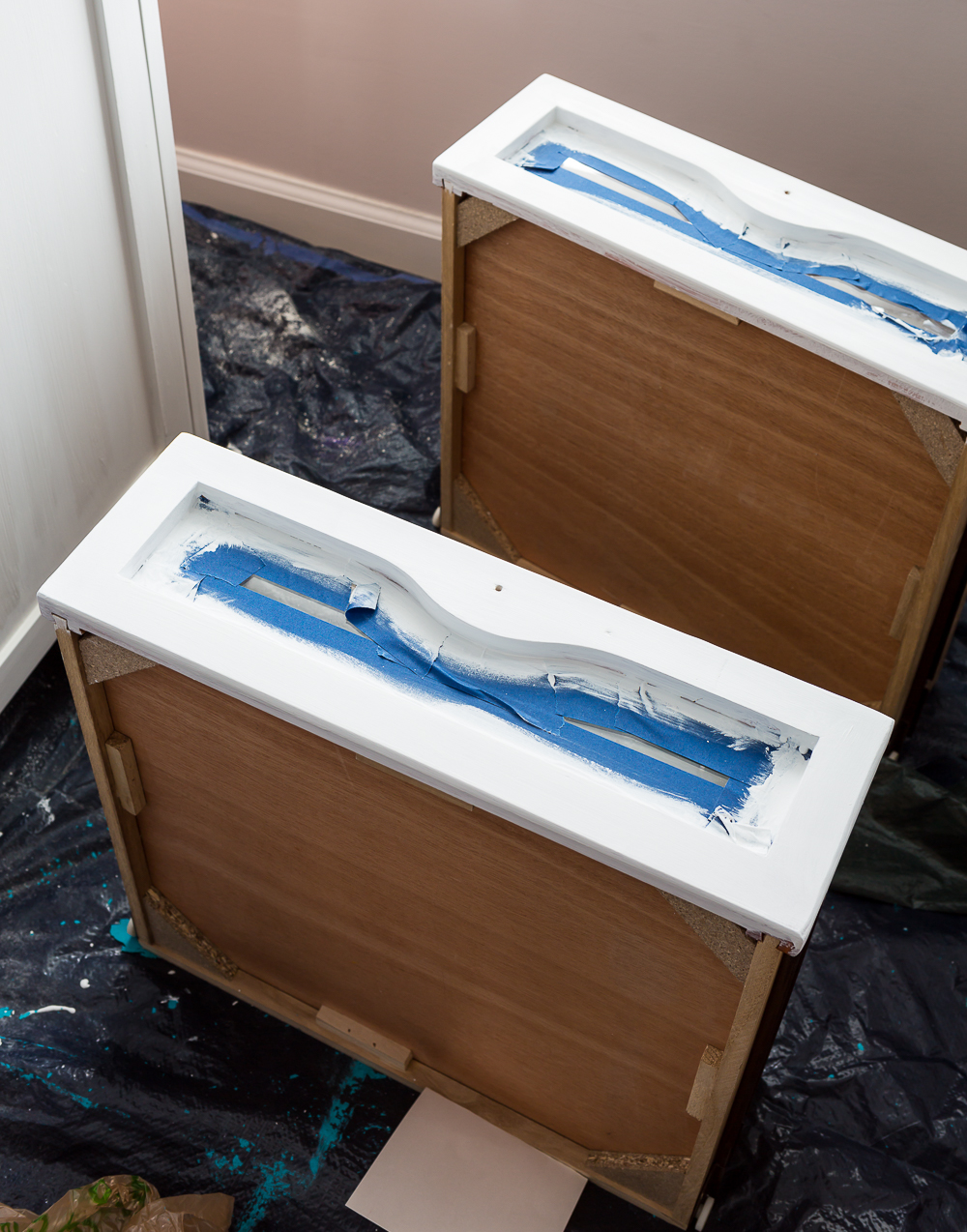 second hand furniture makeover of a changing table's drawers getting painted