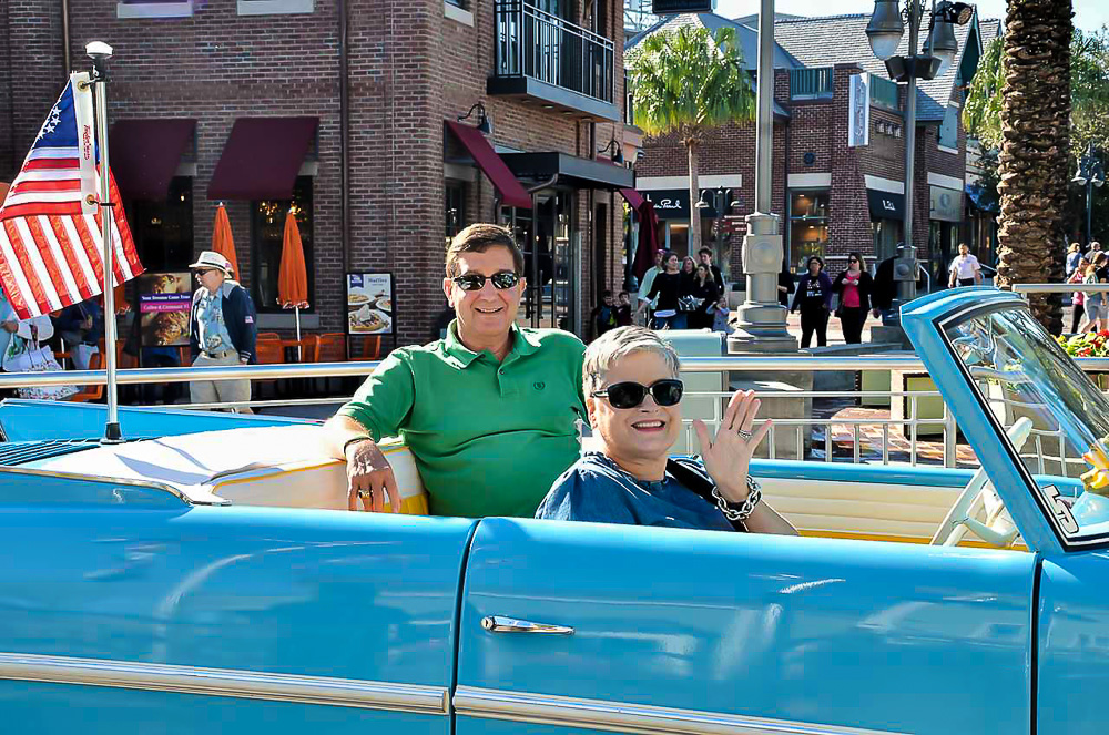 Diane of In My Own Style blog getting a ride in a vintage Amphicar at Disney Springs in Orlando Florida.