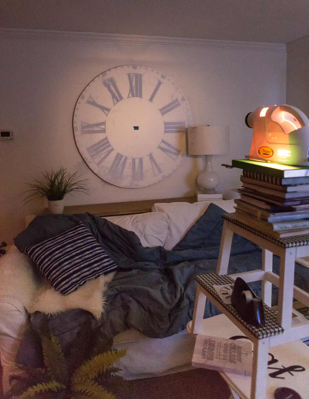 small art projector projecting a clock face on a wall to make an oversized wall clock or mural on a wall.