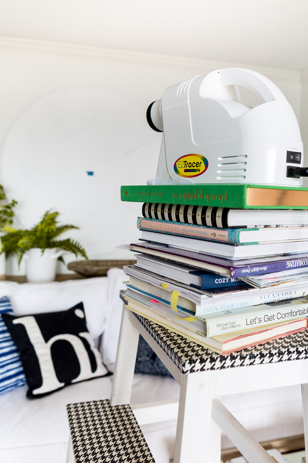 Art projector on stack of books getting ready to help aid in drawing a clock face on a 48" diameter plywood board