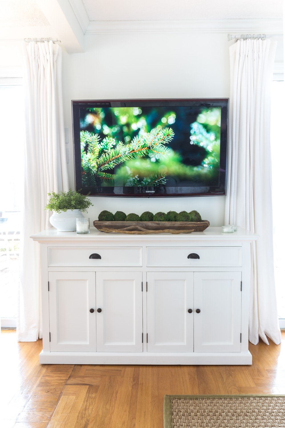 White furniture under wall mounted TV