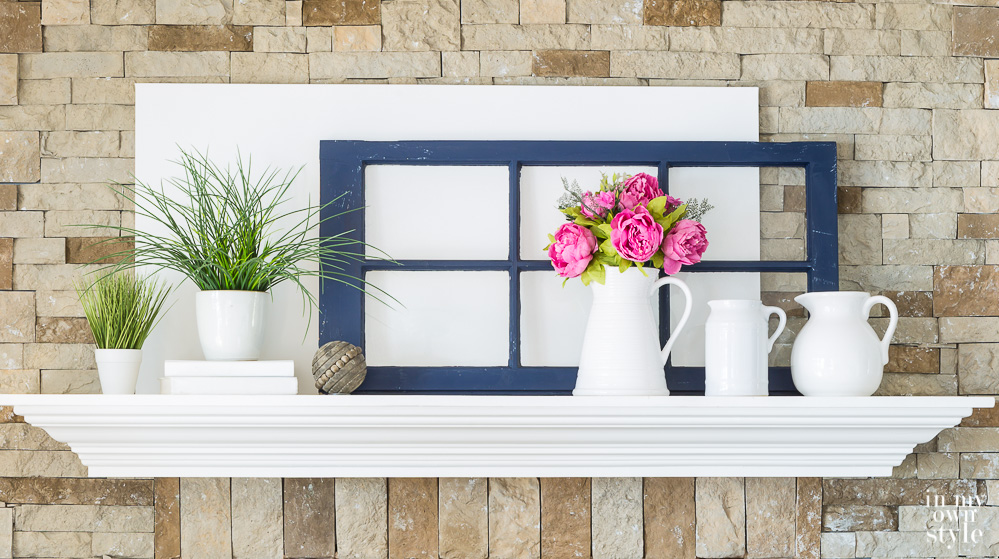 White and navy blue decorated mantel for spring.
