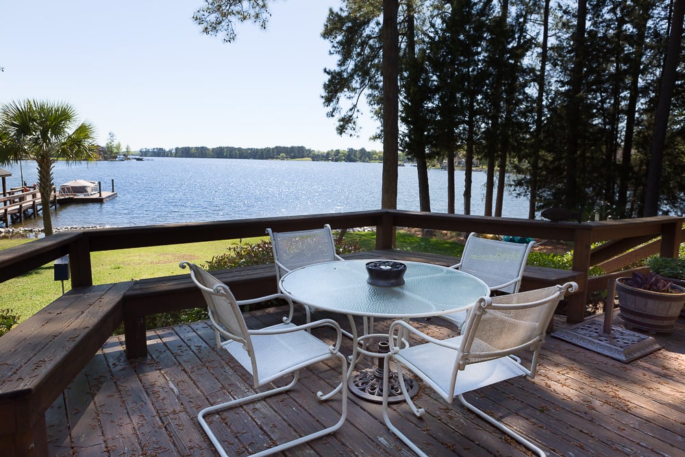 white outdoor table on wood deck