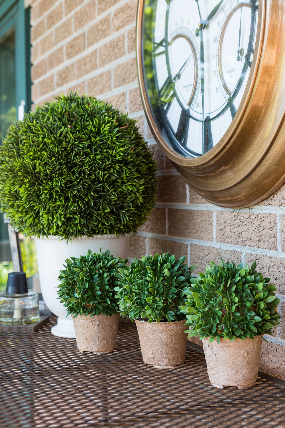Textured stone effect Painted Flower Pots in a line on an outdoor table.