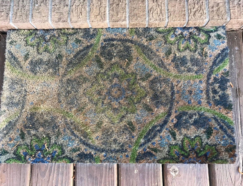 old outdoor coirdoormat that needs to be replaced