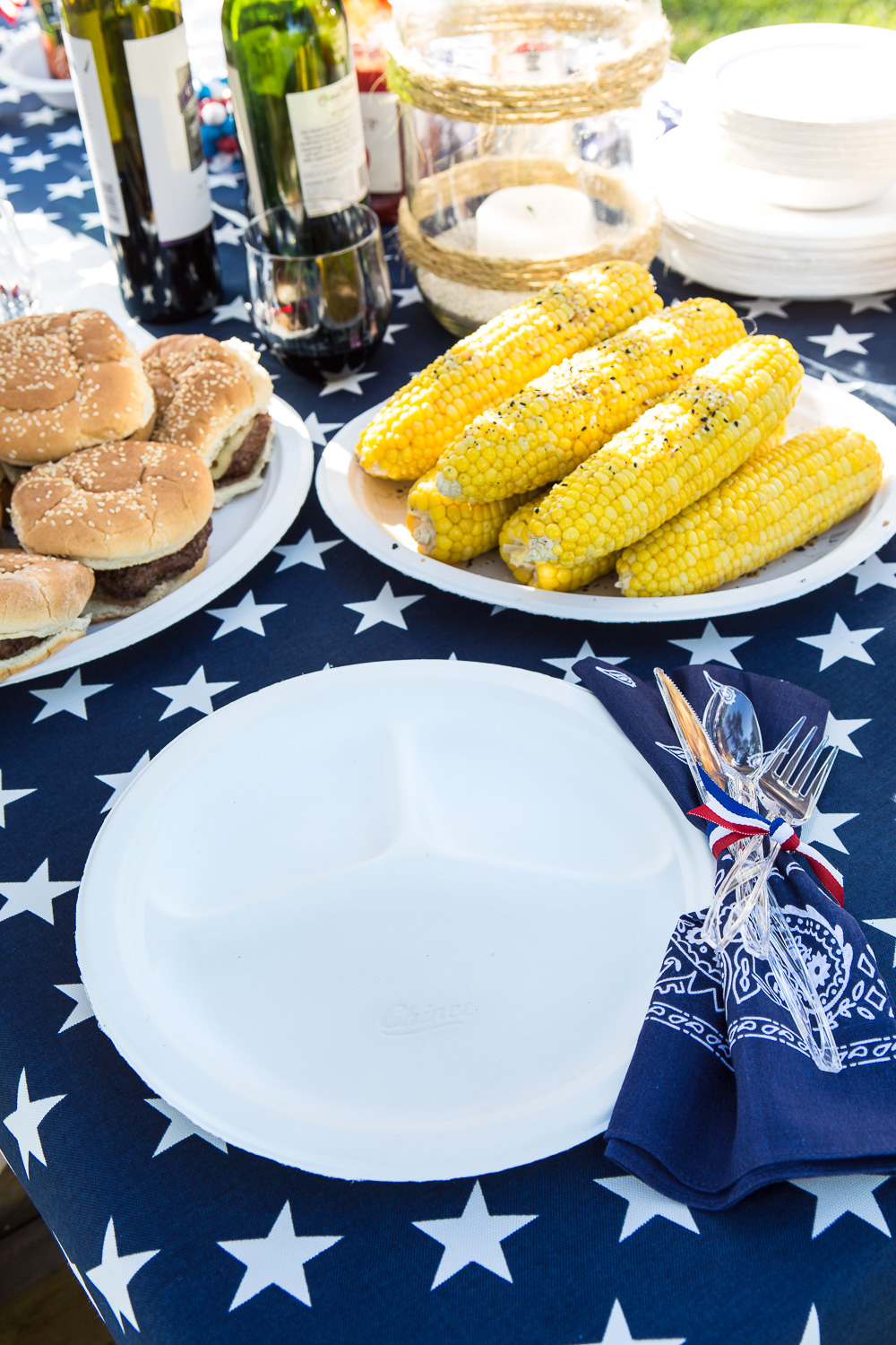 Picnic food set out on red white and blue picnic table
