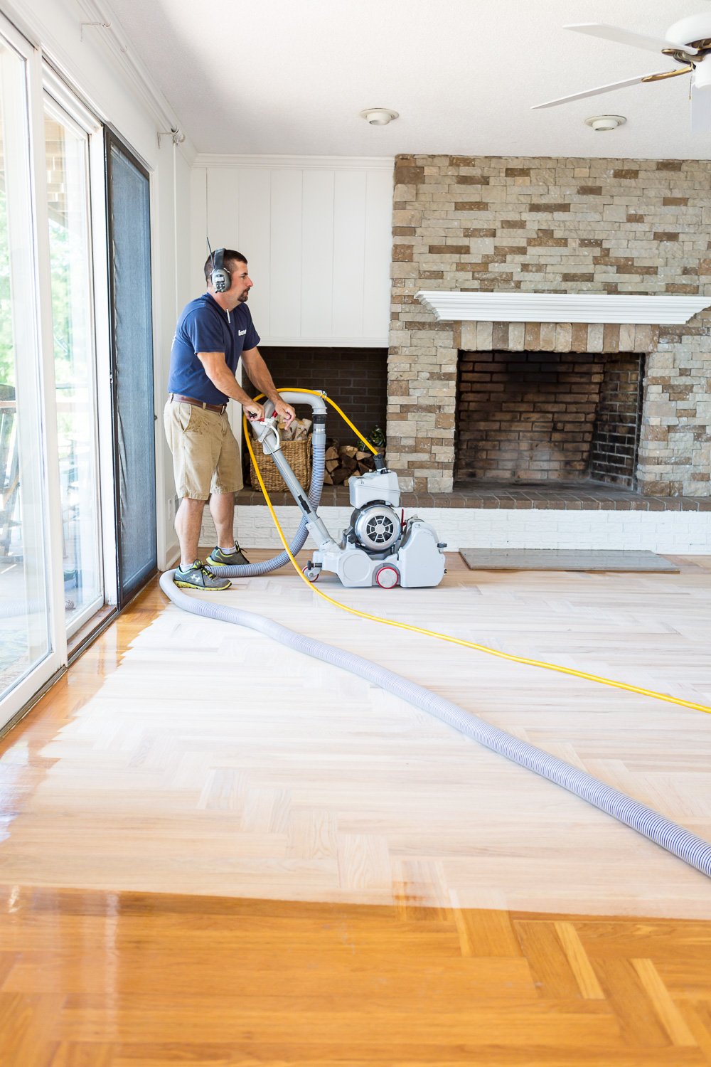 Dustless floor sanding being done by a Bona professional floor refinisher sanding hardwood floor