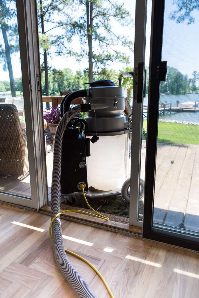 Bona dustless system being used in house floor refinishing project