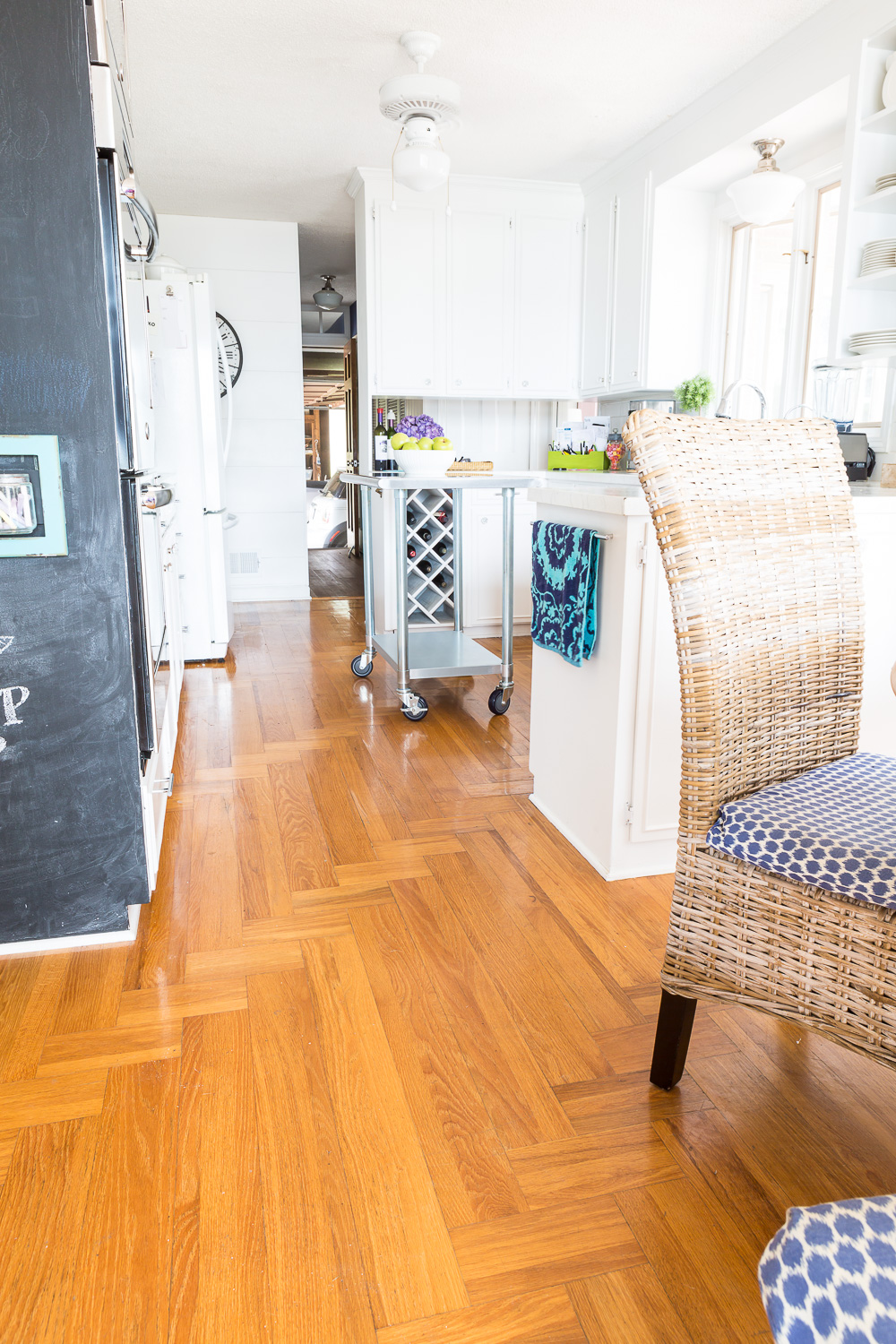 hardwood floor in a kitchen that has turned orange with age.