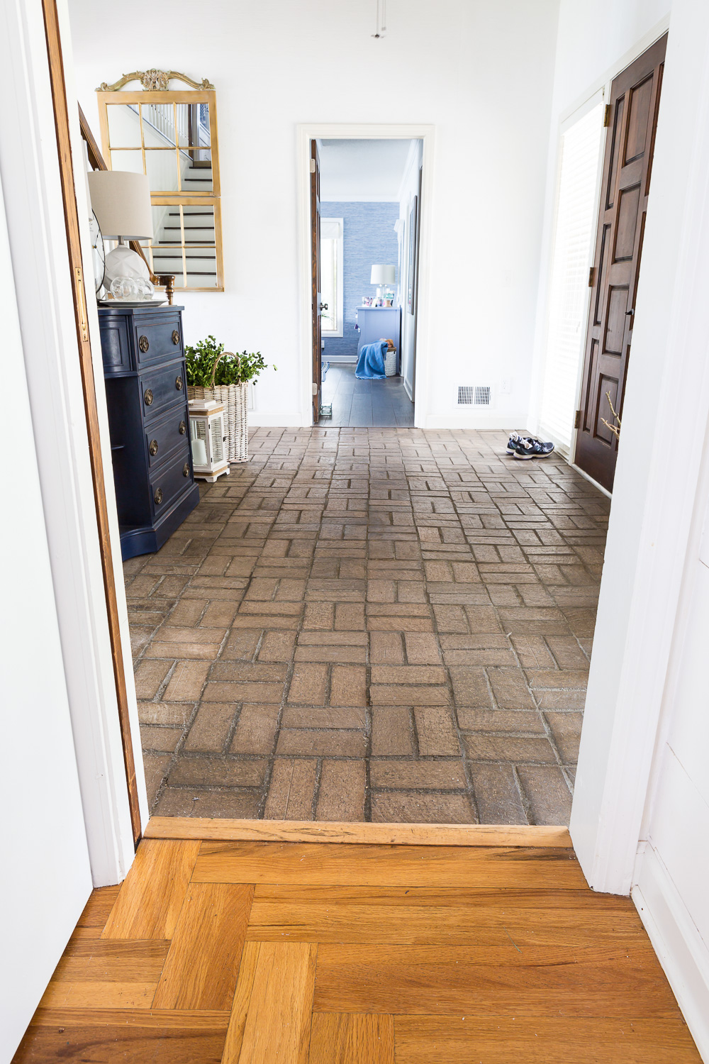 Floor variations in a home from hardwood to brick to laminate.
