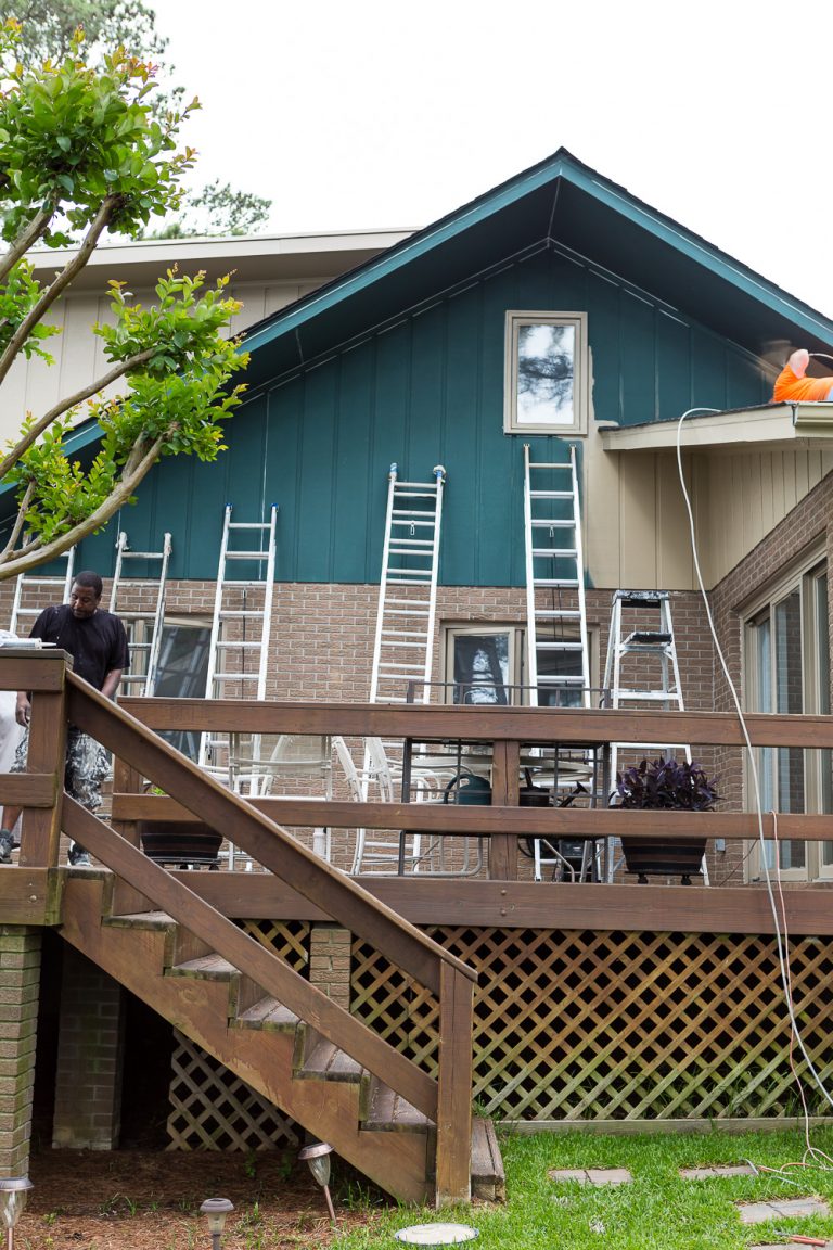 tall ladders propped up along a house