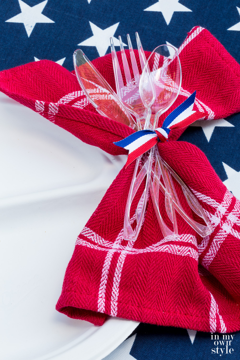 red and white napkin tied onto a Chinet White Compartment plate