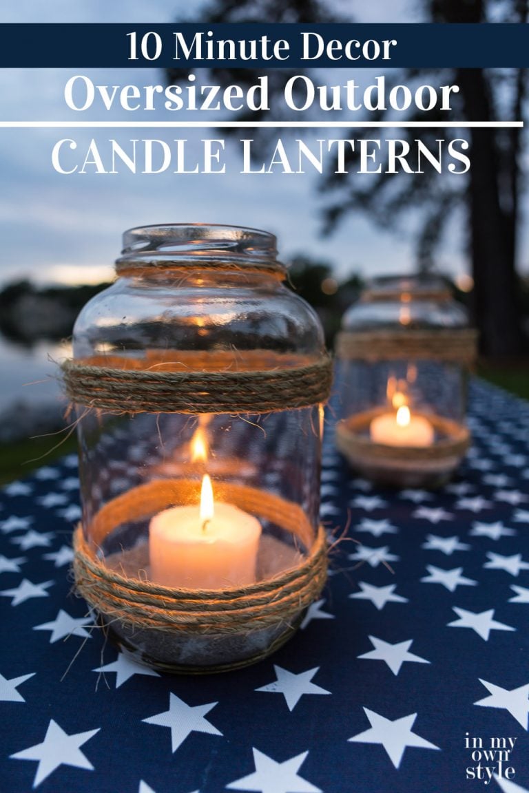 Image of picnic table with a patriotic tablecloth and DIY oversized glass candle lantern to make