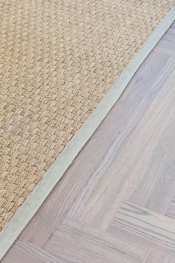 Beige Painted border trim on seagrass rug.