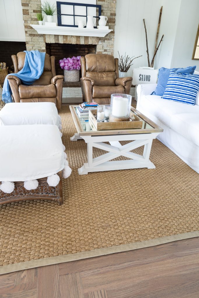 Small living room with seagrass rug with newly painted border trim.