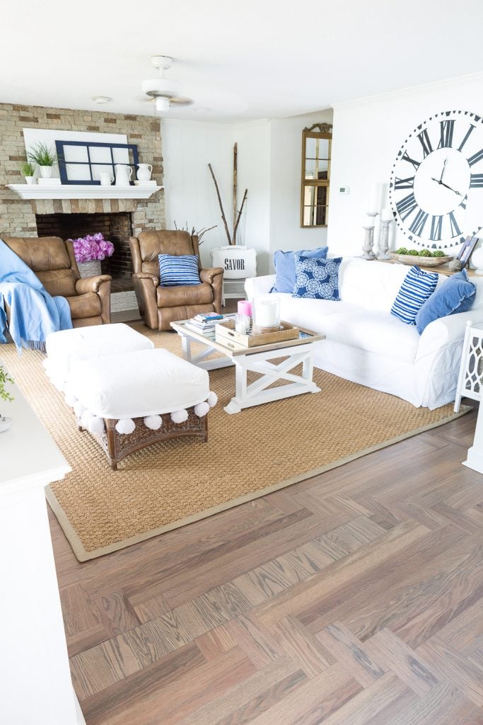 Small living room with natural seagrass area rug with chalk painted border trim