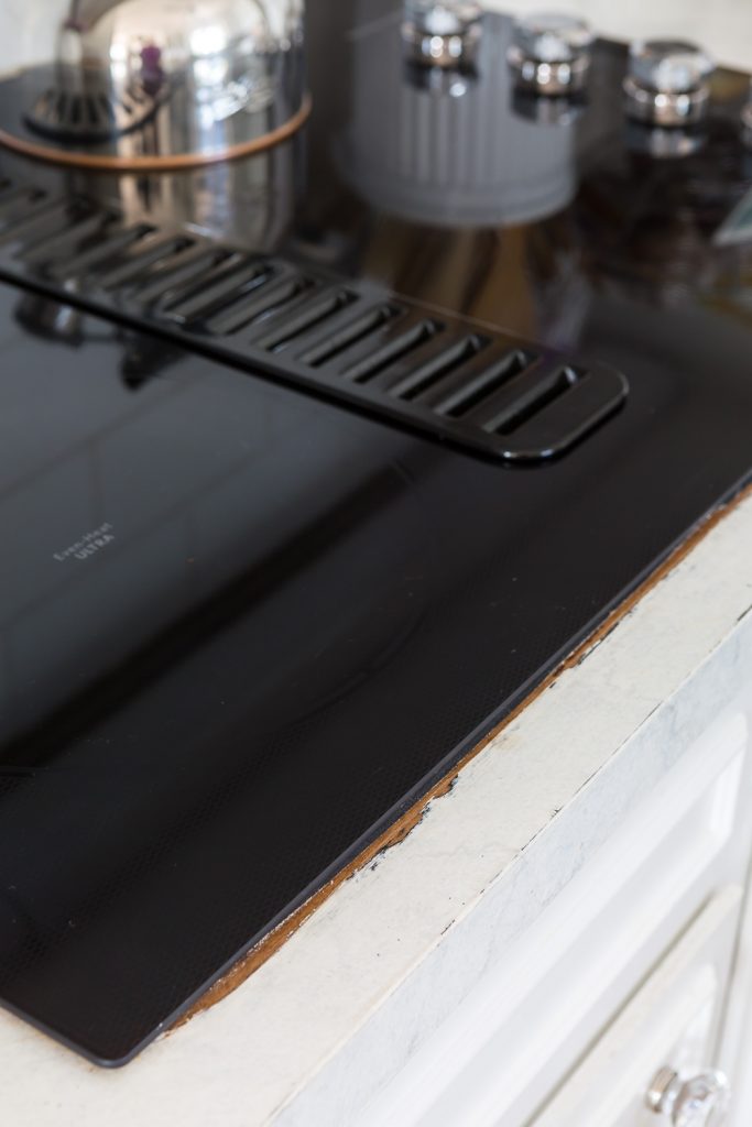 Painted counter showing exposed previous Formica after a new cooktop was installed.