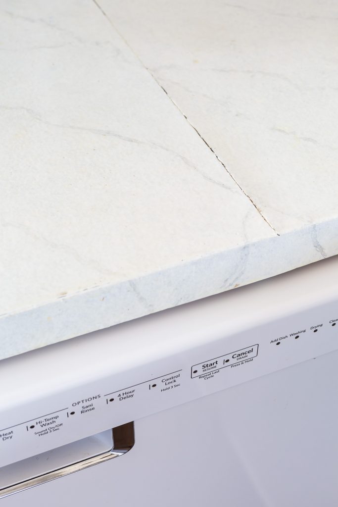 Seam in painted Formica is cracking since it gets heat from the dishwasher under it.