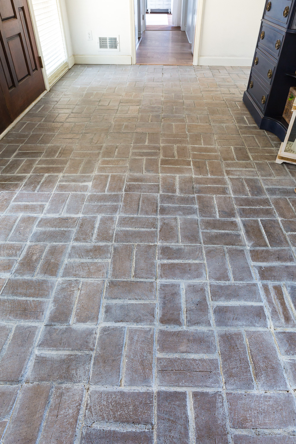 Close-up shot of whitewashed brick floor in entryway foyer.
