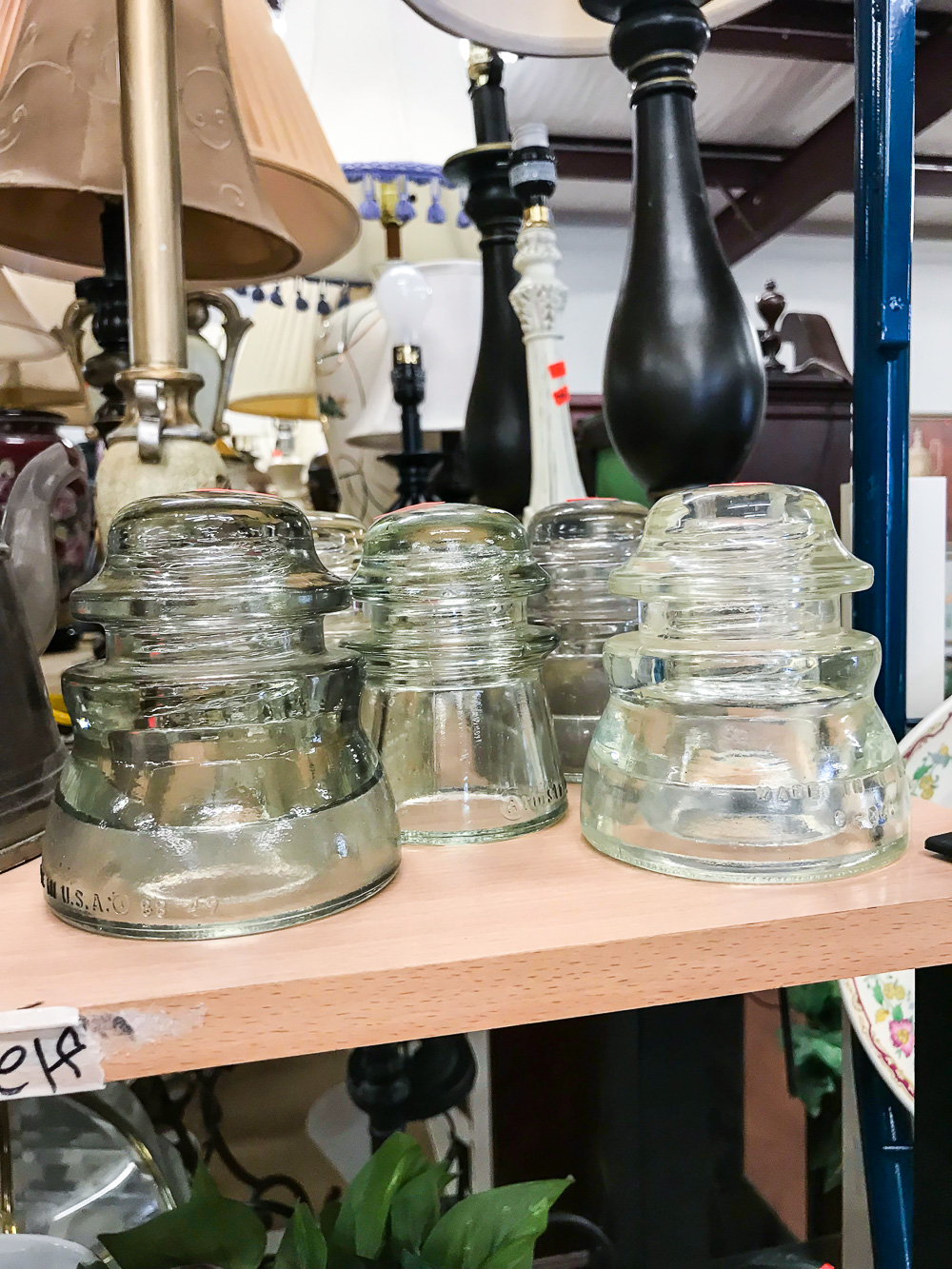 Glass insulators found at a thrift store that can be used in decorating a home.