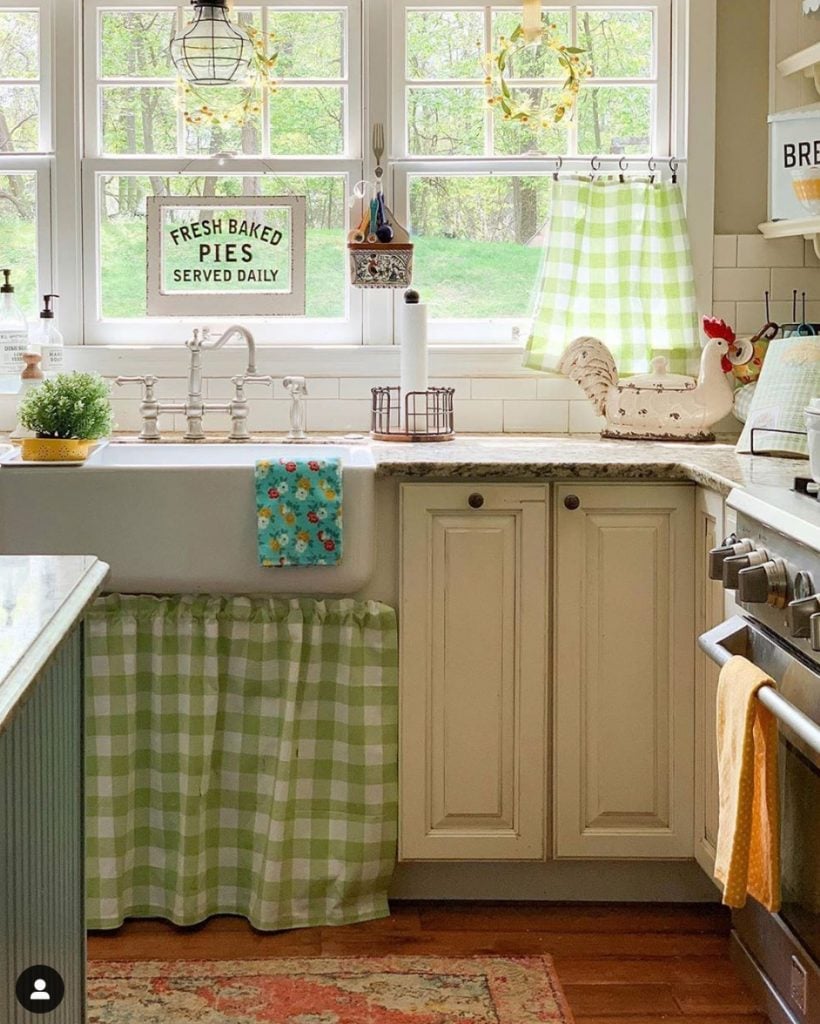 Green and white checked fabric made into a farmhouse sink skirt.
