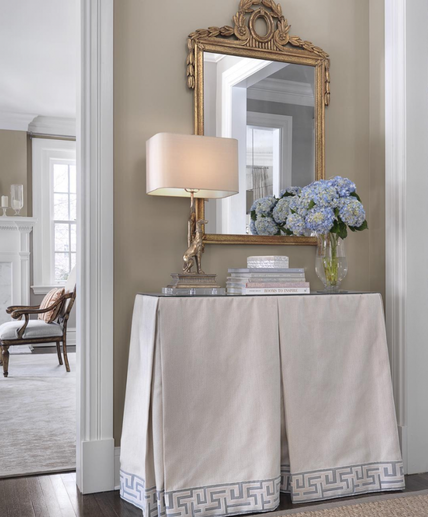 Traditional decor in hallway with a linen covered console table.