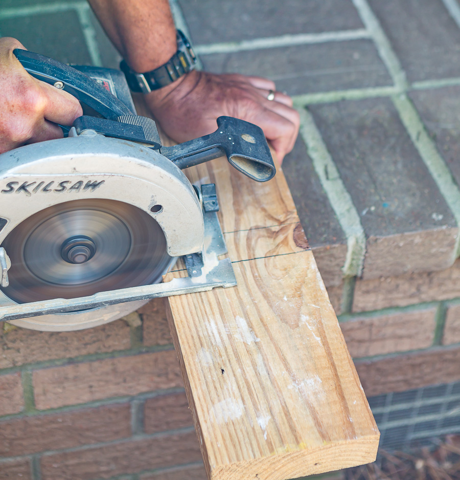cutting a block from a 2 x 6 wood board